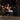 A person performing a squat with a barbell in a gym